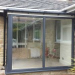 Small orangery with sliding glass doors