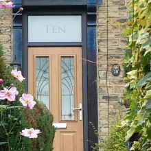 Wood effect front door with decorative glass