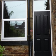 Black front door and side window